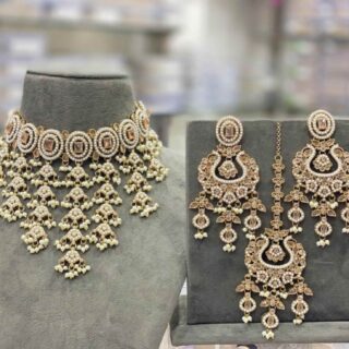 The beautiful white transparent stones clearly arranged, embossed vibrant colorful polki beads stringed by the pearls