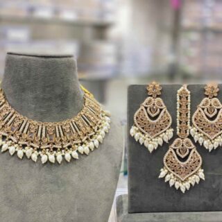 The beautiful white transparent stones clearly arranged, embossed vibrant colorful polki beads stringed by the pearls